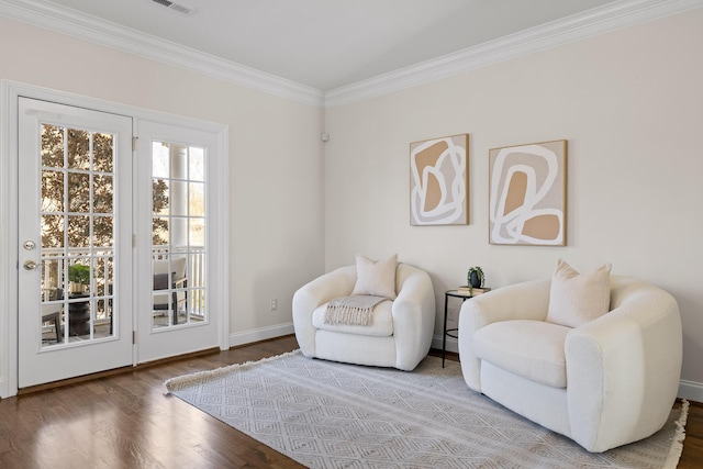 sitting room featuring hardwood / wood-style flooring and ornamental molding