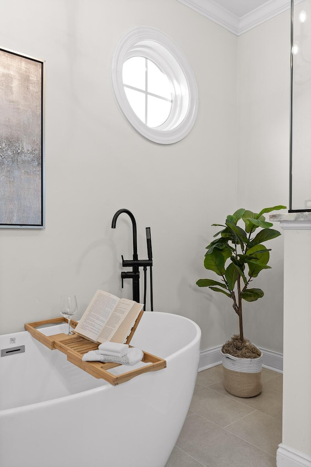 bathroom with tile patterned flooring, ornamental molding, and a bath