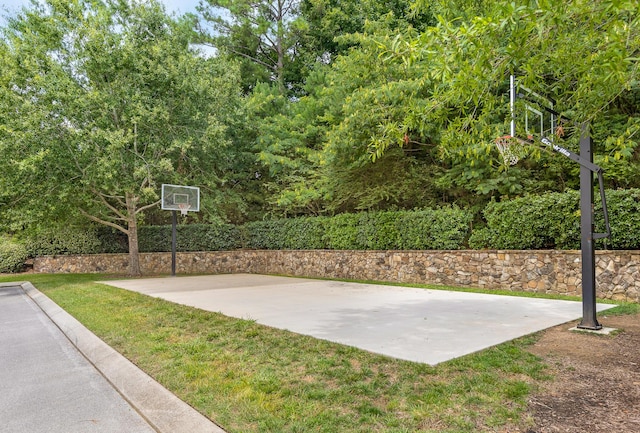 view of basketball court with a lawn