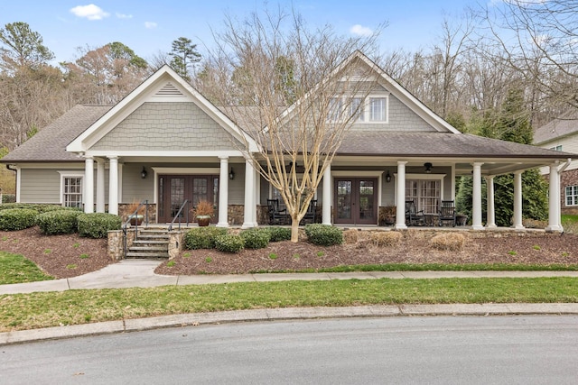 craftsman-style house with french doors and covered porch