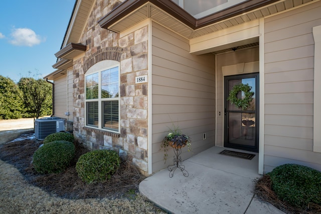 view of exterior entry with central AC unit