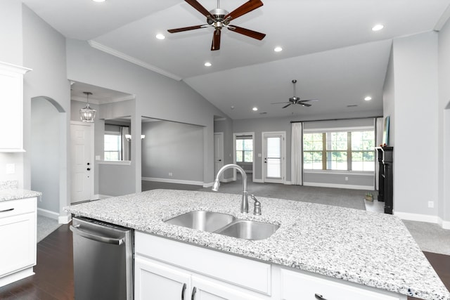 kitchen featuring sink, stainless steel dishwasher, white cabinetry, and light stone counters