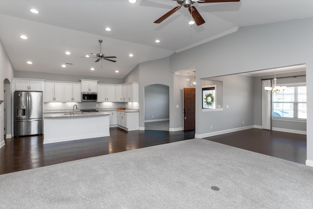 kitchen featuring a kitchen island with sink, stainless steel appliances, dark wood-type flooring, white cabinets, and ceiling fan with notable chandelier