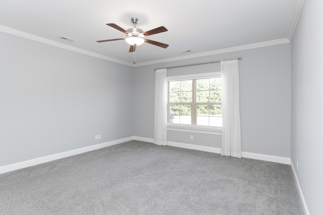 carpeted empty room featuring ceiling fan and crown molding