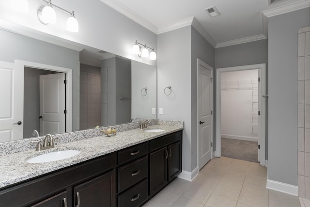 bathroom with ornamental molding, tile patterned floors, and vanity