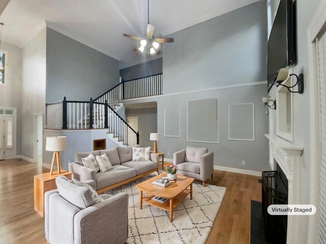 living room featuring ceiling fan, light hardwood / wood-style flooring, and high vaulted ceiling