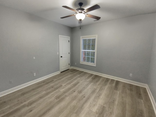 spare room featuring ceiling fan and light wood-type flooring