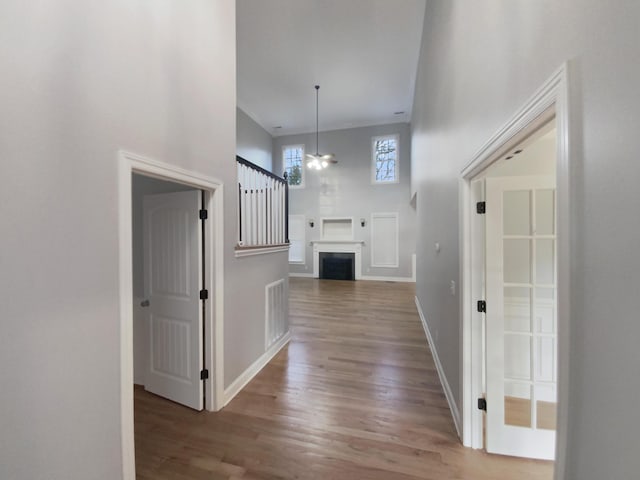 corridor with hardwood / wood-style floors