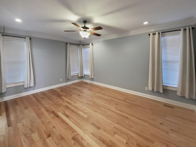 empty room featuring ceiling fan, light hardwood / wood-style flooring, and crown molding