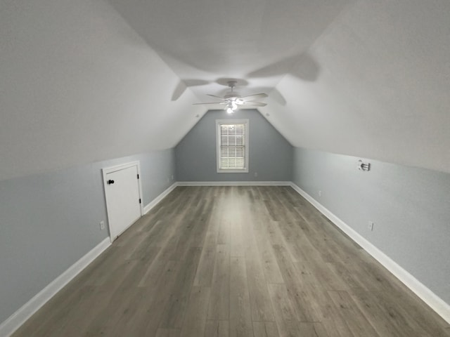 additional living space with lofted ceiling, ceiling fan, and wood-type flooring