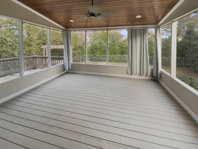 unfurnished sunroom with vaulted ceiling, ceiling fan, and wooden ceiling