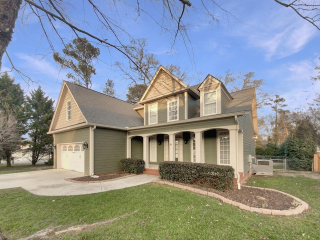 view of front of house with a porch, a garage, and a front yard