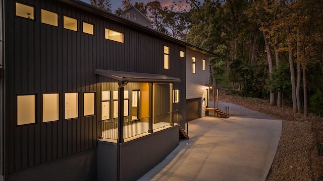 property exterior at dusk featuring a garage