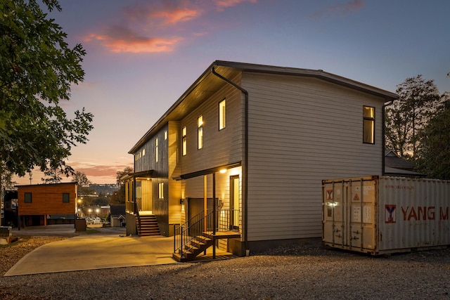 view of back house at dusk