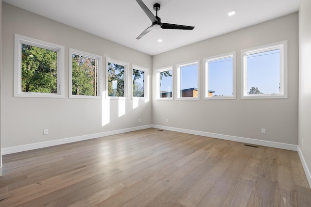 unfurnished room with ceiling fan and light hardwood / wood-style flooring