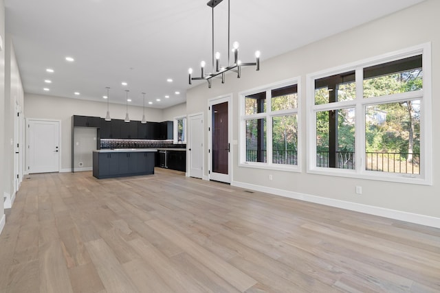 kitchen with a kitchen island, a wealth of natural light, and hanging light fixtures