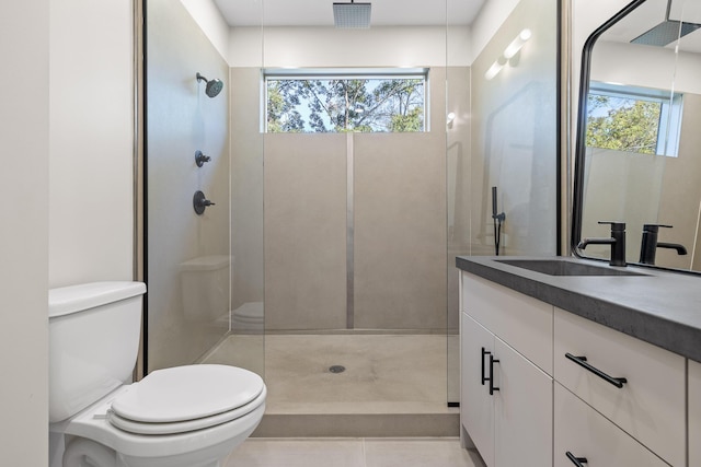 bathroom with walk in shower, a wealth of natural light, vanity, and toilet