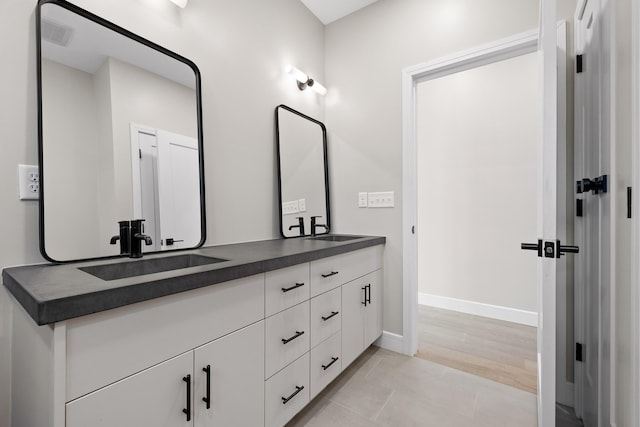 bathroom with tile patterned flooring and vanity