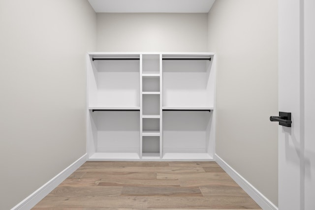 walk in closet featuring light hardwood / wood-style flooring