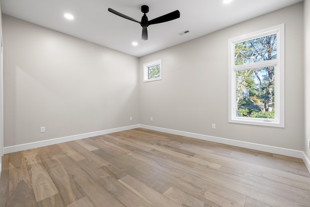 spare room featuring ceiling fan and light hardwood / wood-style flooring