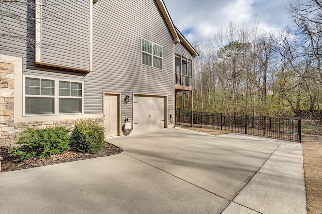 view of side of property with a sunroom and a garage