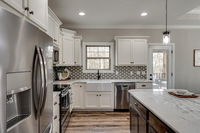 kitchen featuring stainless steel appliances, white cabinets, sink, and backsplash