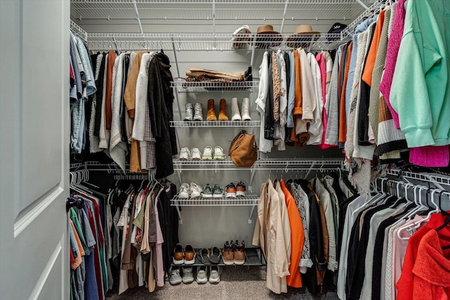 walk in closet featuring carpet