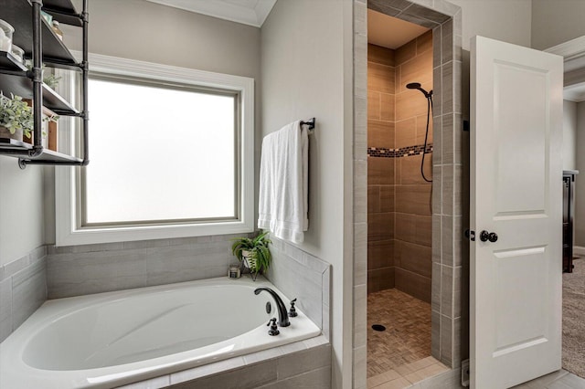 bathroom with shower with separate bathtub, ornamental molding, and a wealth of natural light