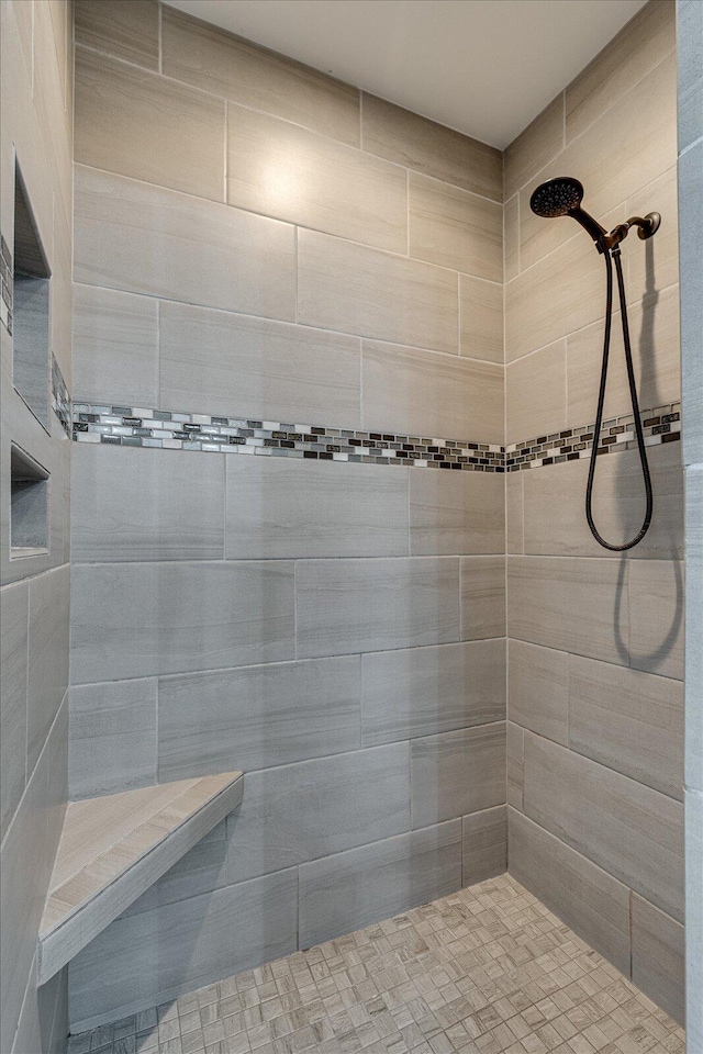 bathroom with a tile shower