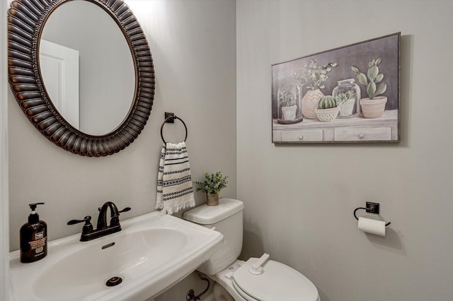 bathroom featuring toilet and sink