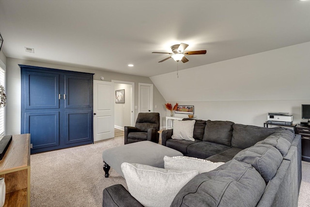 living room featuring ceiling fan, vaulted ceiling, and light carpet