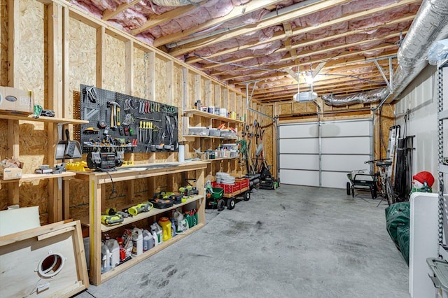 garage with a workshop area and a garage door opener