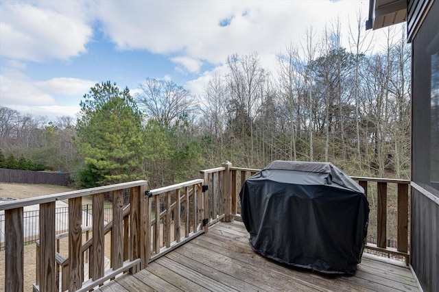 wooden terrace featuring a grill