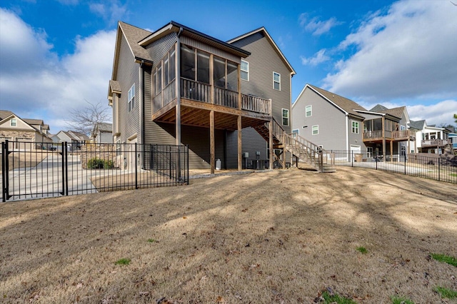 rear view of property featuring a sunroom