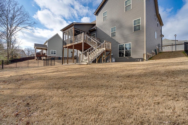 rear view of property with a yard and a deck