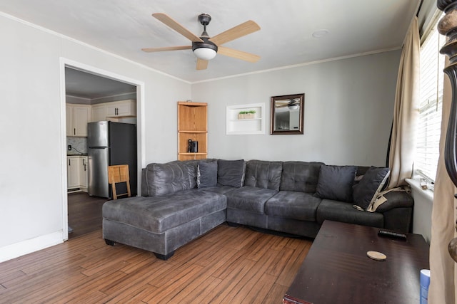 living room with ceiling fan, ornamental molding, and dark hardwood / wood-style flooring