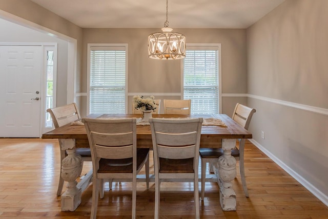 dining room featuring an inviting chandelier and light hardwood / wood-style floors