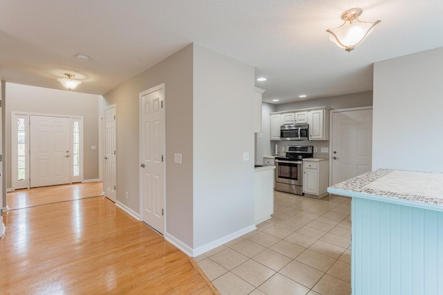 foyer entrance with light tile patterned floors