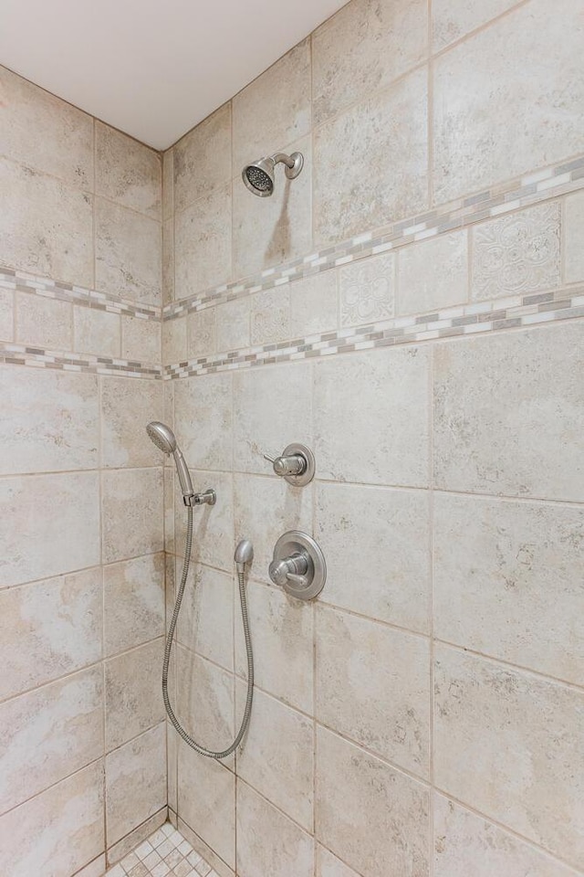 bathroom with a tile shower