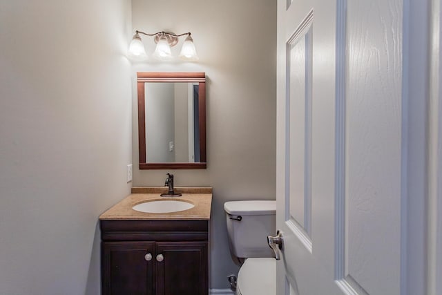 bathroom with toilet and vanity