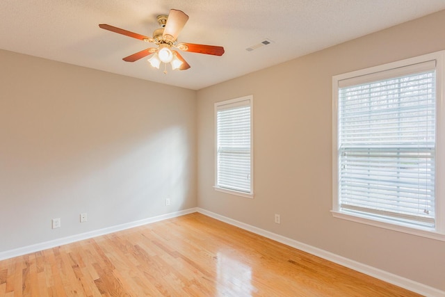 spare room with light hardwood / wood-style floors and ceiling fan