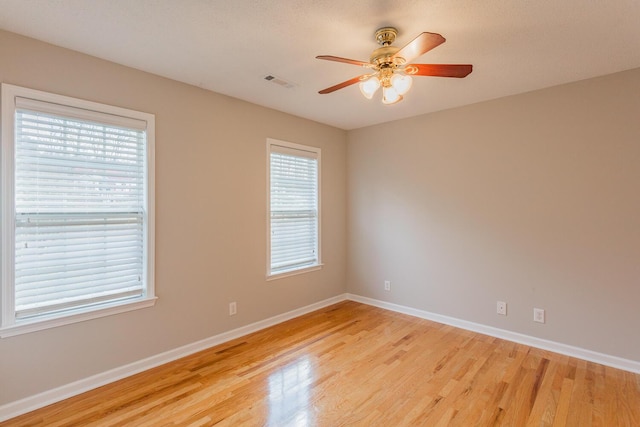 empty room featuring ceiling fan and light hardwood / wood-style flooring