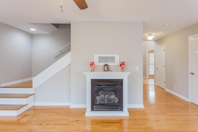 unfurnished living room featuring ceiling fan and light hardwood / wood-style flooring