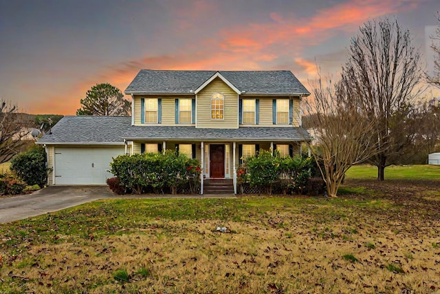 view of front of home with a yard and a garage