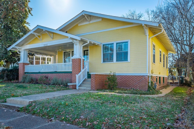 view of front of house with a front yard and a porch