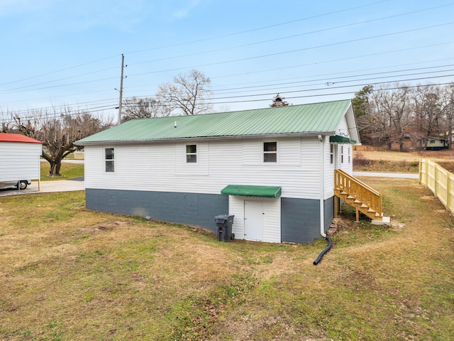 view of side of home with a yard