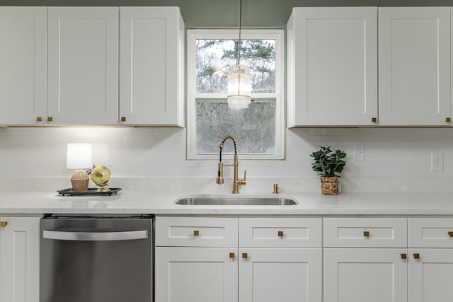 kitchen with sink, white cabinetry, stainless steel dishwasher, and decorative backsplash