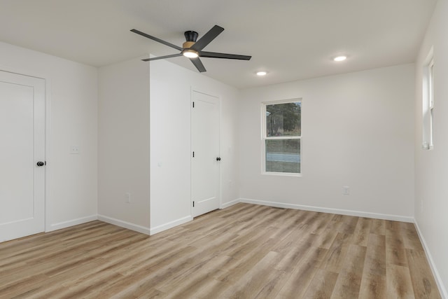 unfurnished bedroom with ceiling fan and light hardwood / wood-style flooring