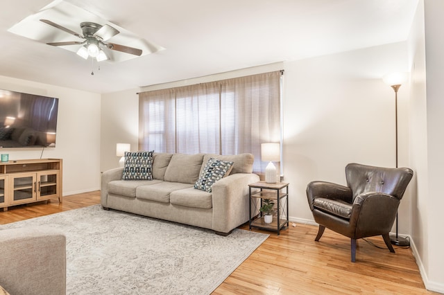 living room with ceiling fan and hardwood / wood-style flooring