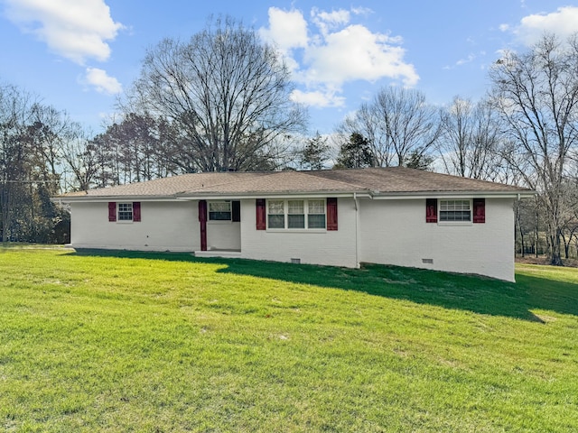 rear view of property with a yard